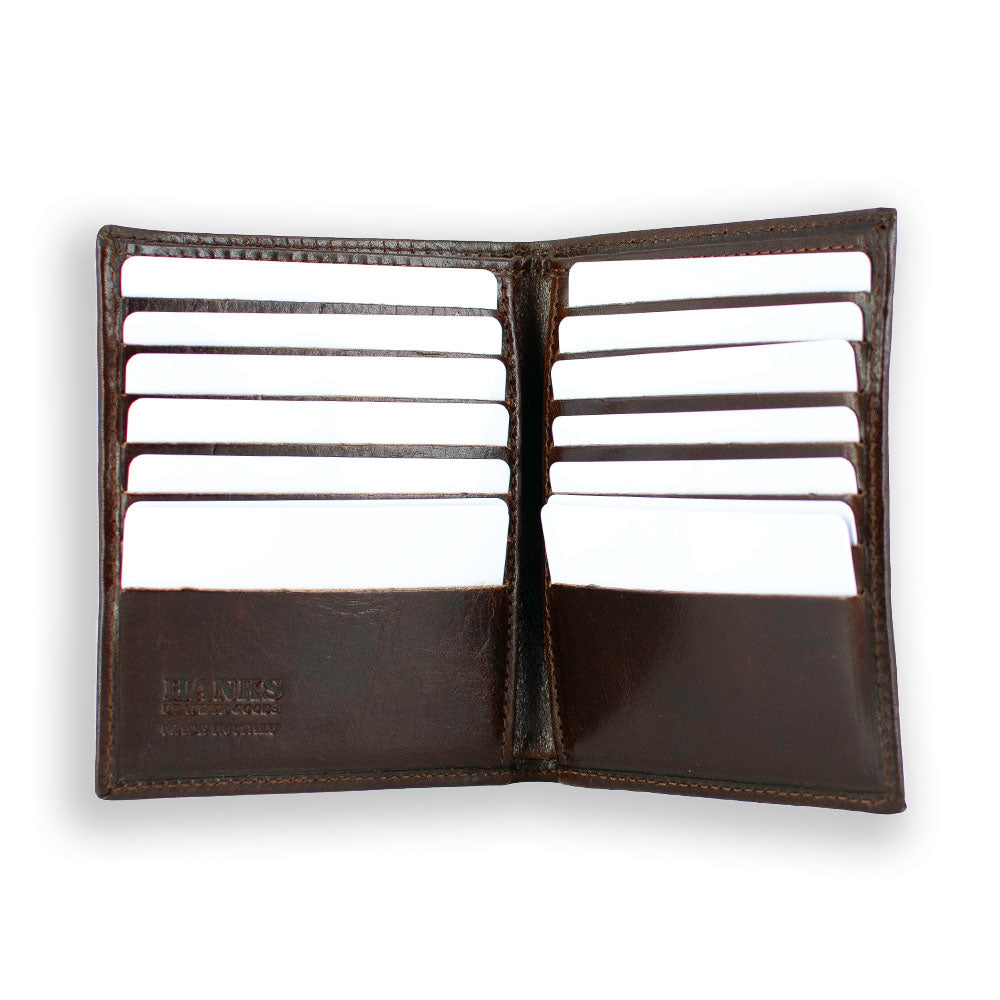 The Iseo Italian Hipster Bifold from Hanks Belts is an open brown leather wallet with several white cards visible in its 14 credit card slots, arranged in two rows on either side. The wallet&#39;s simple and organized design is prominently displayed on a plain white background.