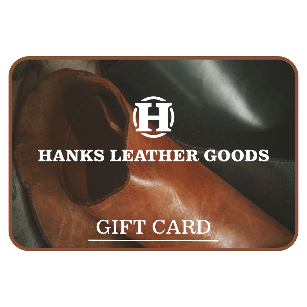 The &quot;Hanks Belts Gift Card&quot; from Hanks Belts displays the text &quot;Hanks Leather Goods&quot; and &quot;Gift Card&quot; on pieces of brown and black leather. Ideal for last-minute gifting, it features a stylized letter &quot;H&quot; at its center, providing the perfect choice for any recipient.