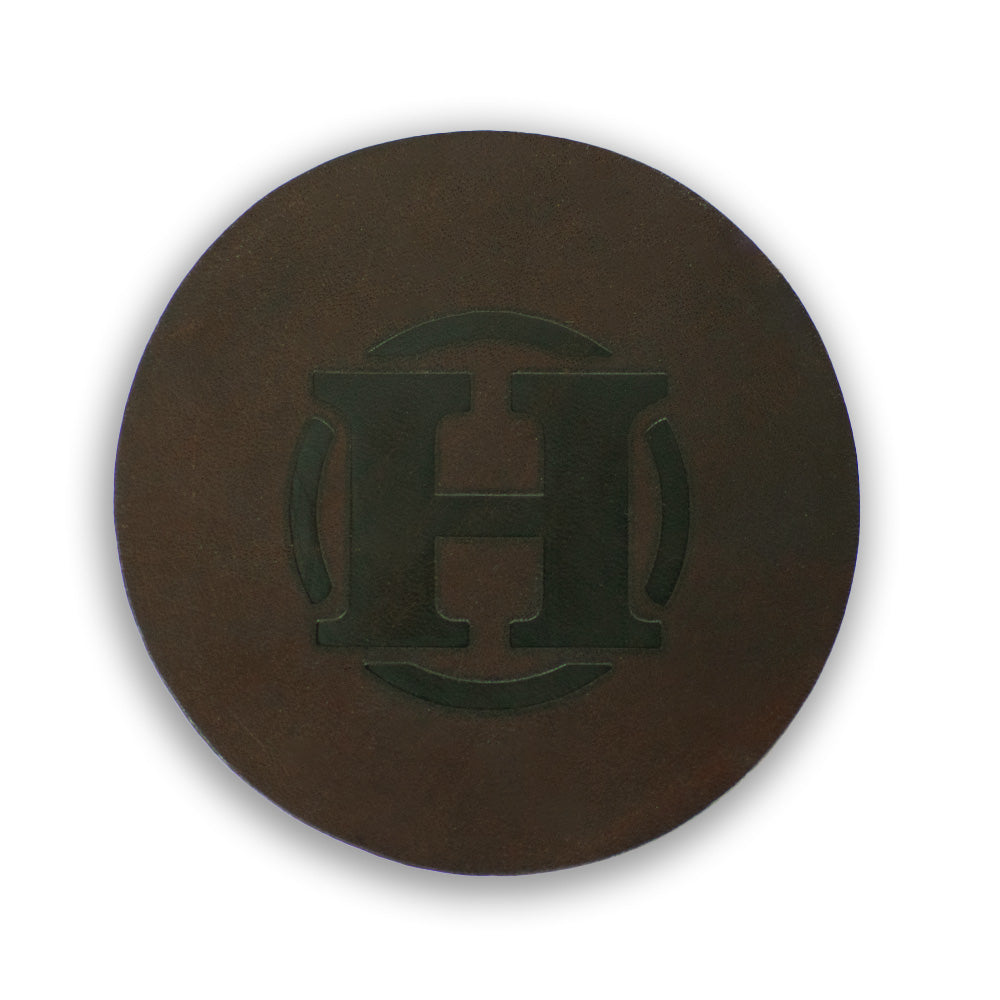 Round Leather coaster hero image in rich brown