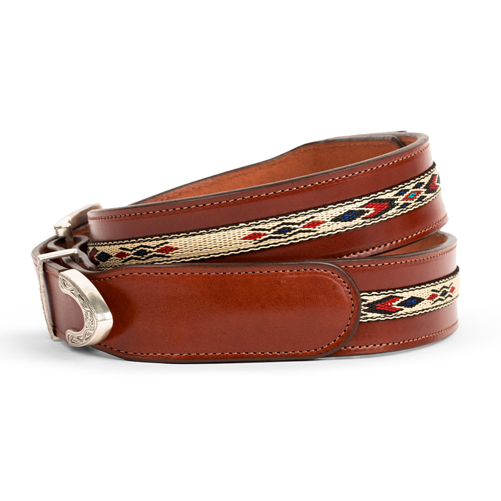 The Seneca - 1.5&quot; by Hanks Belts is a brown leather belt with an Aztec pattern inlay of red, black, and beige, finished with a silver buckle. The design along the middle gives it a western touch and it&#39;s crafted from Premium English Bridle Leather.