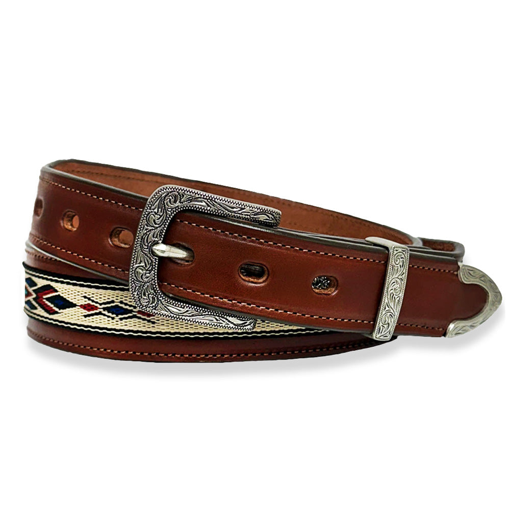 The Seneca - 1.5&quot; by Hanks Belts, in a rich Oak color, boasts decorative stitching and an intricate silver buckle and tip. Crafted from Premium English Bridle Vegetable-Tanned Leather, it features multiple holes for size adjustment and a detailed embroidered Aztec pattern along its length, adding a sophisticated touch.