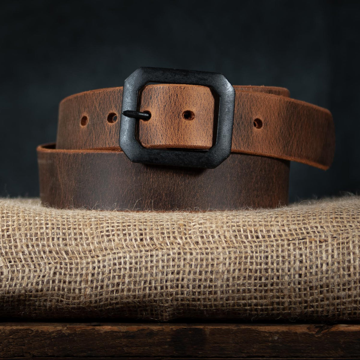 relic belt with black buckle on burlap