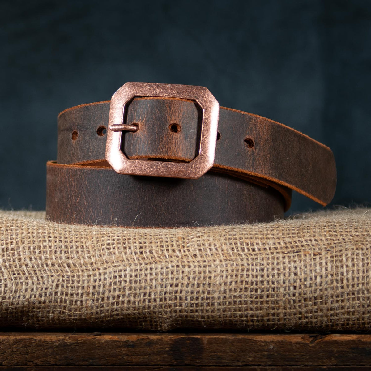 relic belt with antique copper buckle on burlap