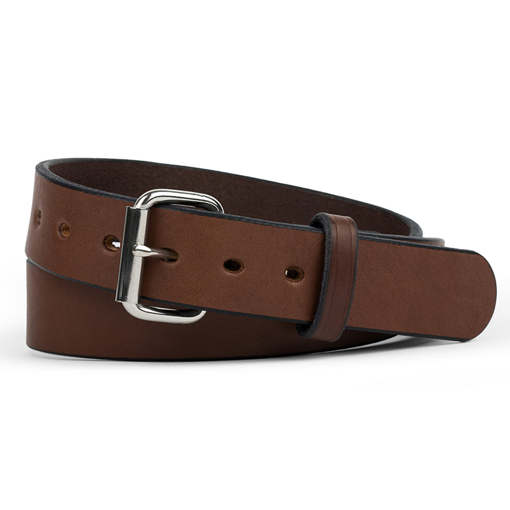 A rolled-up Hanks Belts &quot;The Gunner - 1.5” crafted from full-grain brown leather with a sleek silver buckle and multiple holes, elegantly displayed on a plain white background.