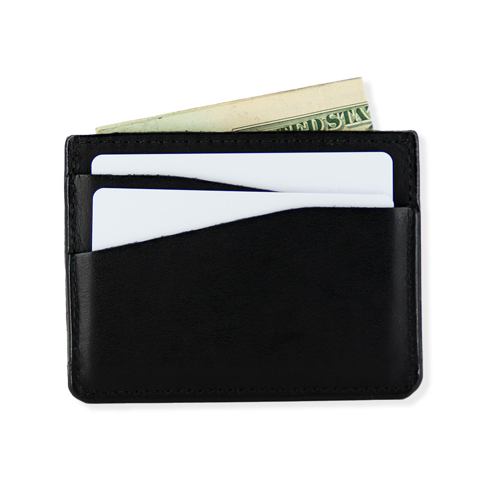 A minimalist black Cumberland Bison Card Holder by Hanks Belts, made in the USA, holding two white cards and a partially visible folded U.S. dollar bill. The wallet features two card slots and an additional central pocket for cash.