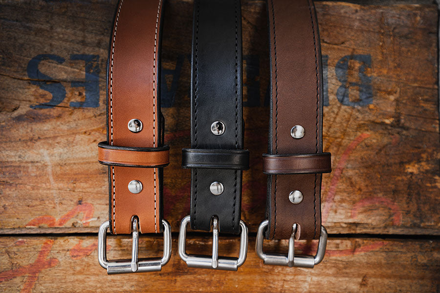 Three Hanks Carry belts hanging over wooden box