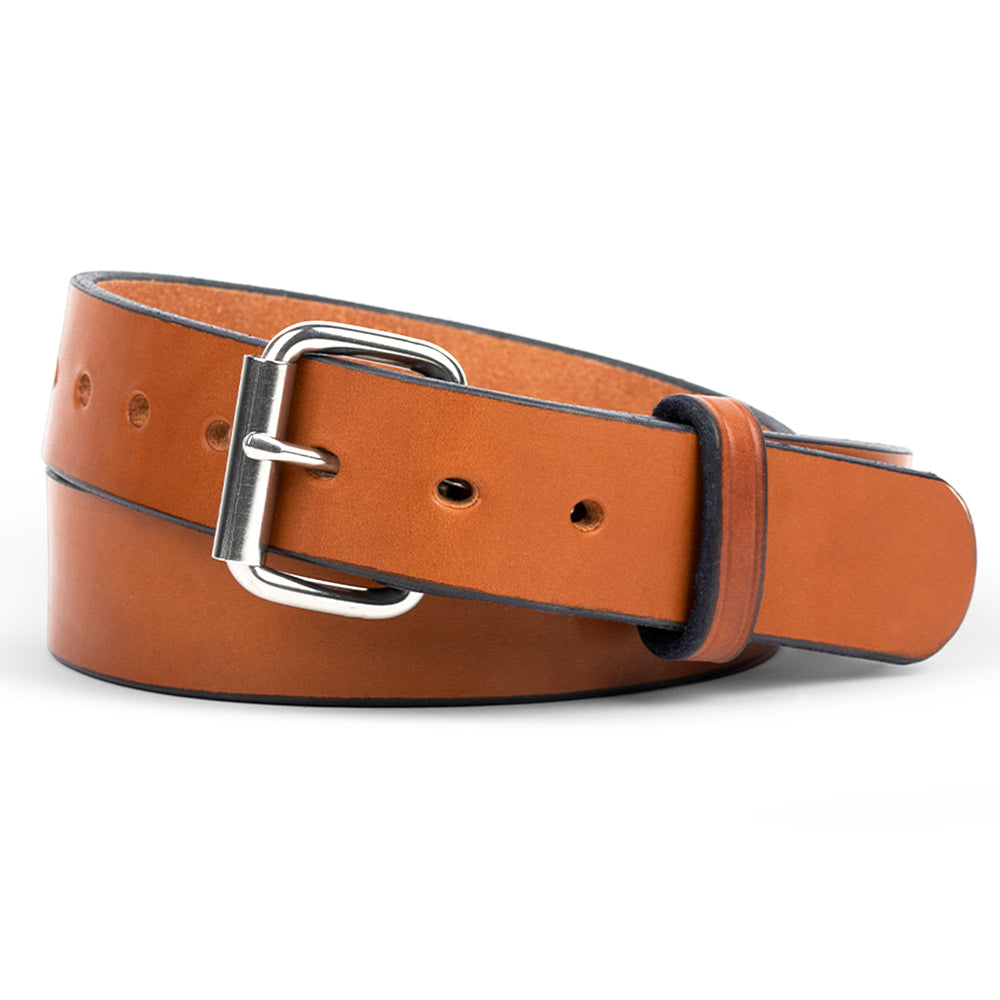 The Gunner - 1.5&quot; by Hanks Belts is a rolled-up belt crafted from full-grain steer hide, featuring a silver metal buckle and multiple holes, elegantly displayed against a white background.