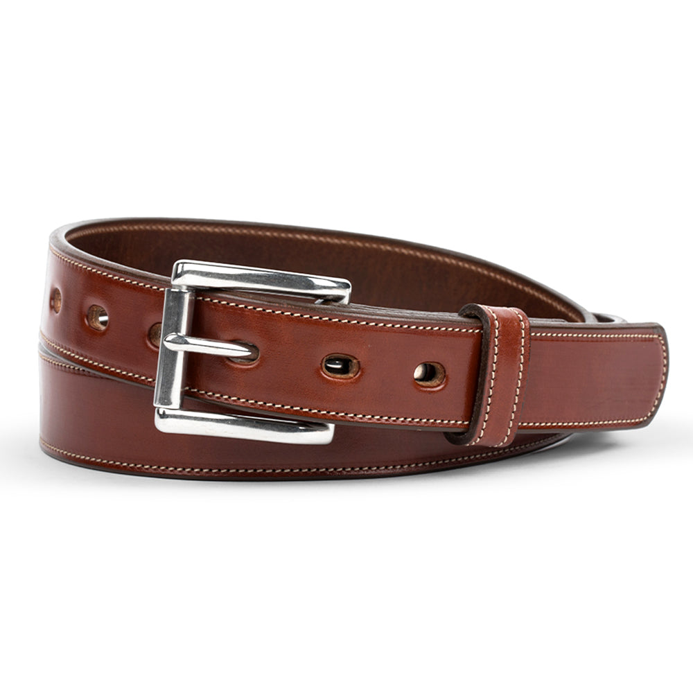 The Highland - 1.25&quot; by Hanks Belts is a rolled belt made from vegetable-tanned leather, featuring a shiny silver buckle and multiple holes. Double-stitched edges highlight its exceptional craftsmanship and durability.