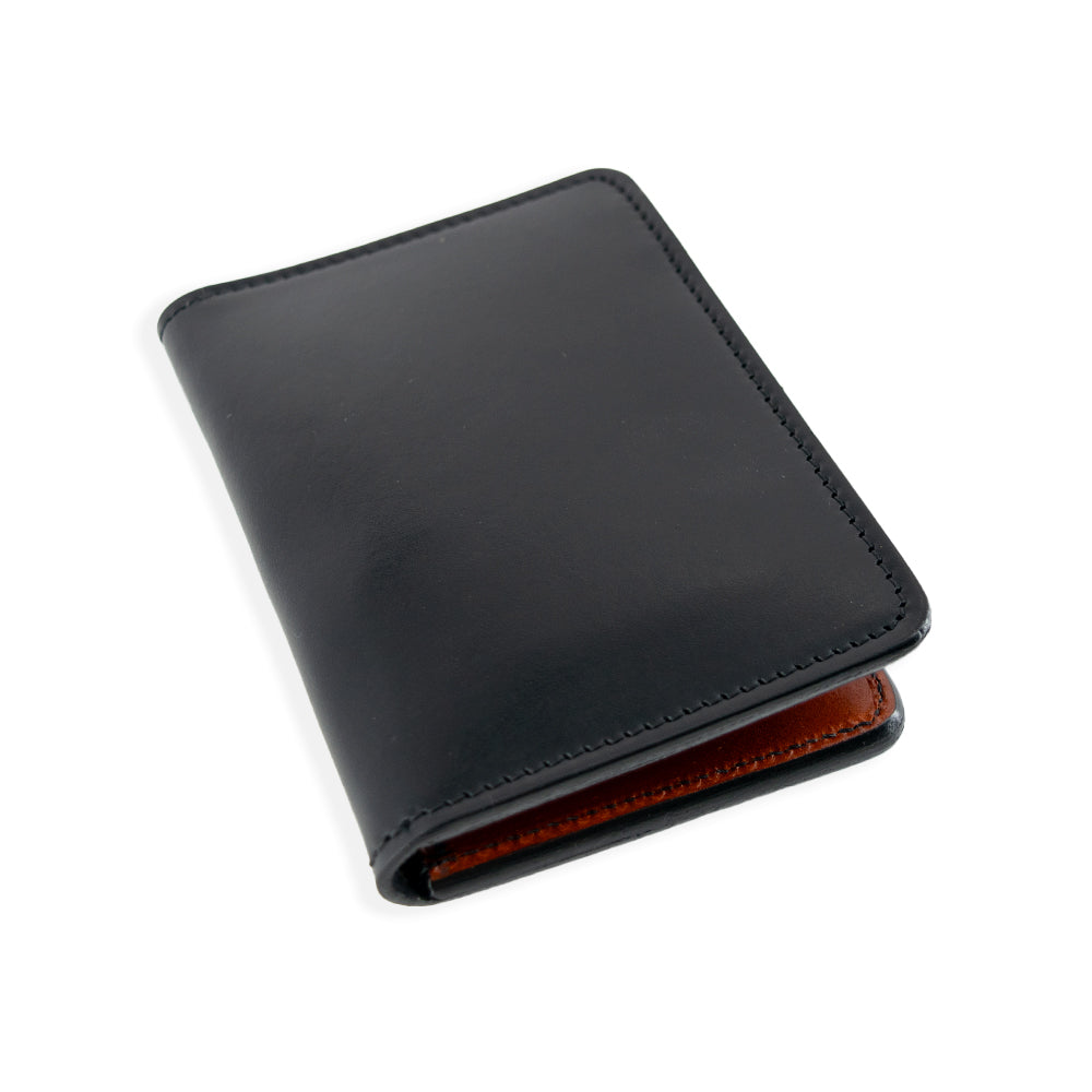 The Superior Front Pocket Bifold by Hanks Belts is an artisan-crafted USA-made black leather bi-fold wallet with visible stitching and a brown interior. Made from premium harness leather, it is shown closed against a plain white background.