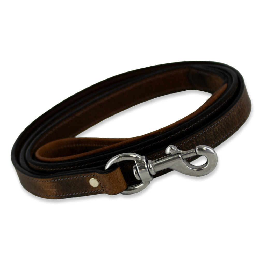 A Kodak Leash from Hanks Belts lies coiled, crafted from Premium Bison Leather with stainless steel hardware. The leash showcases a loop handle at one end and a metal clasp at the other for attaching to a collar, along with natural leather texture and detailed stitching along the edges.