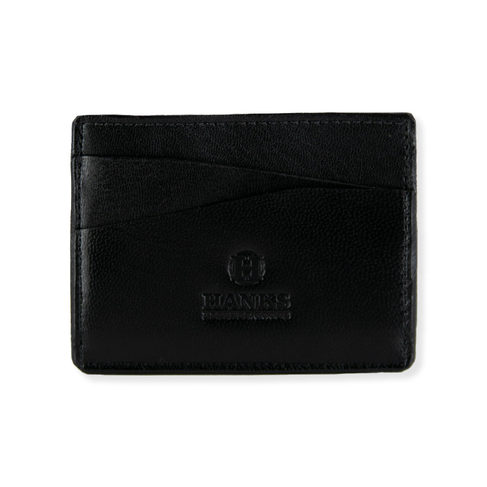 The Hanks Belts Monroe Goatskin Card Holder is a black minimalist wallet made from goatskin leather, featuring a slim profile. The elegant design includes multiple staggered card slots at the top, displayed in a visually appealing manner against a white background.