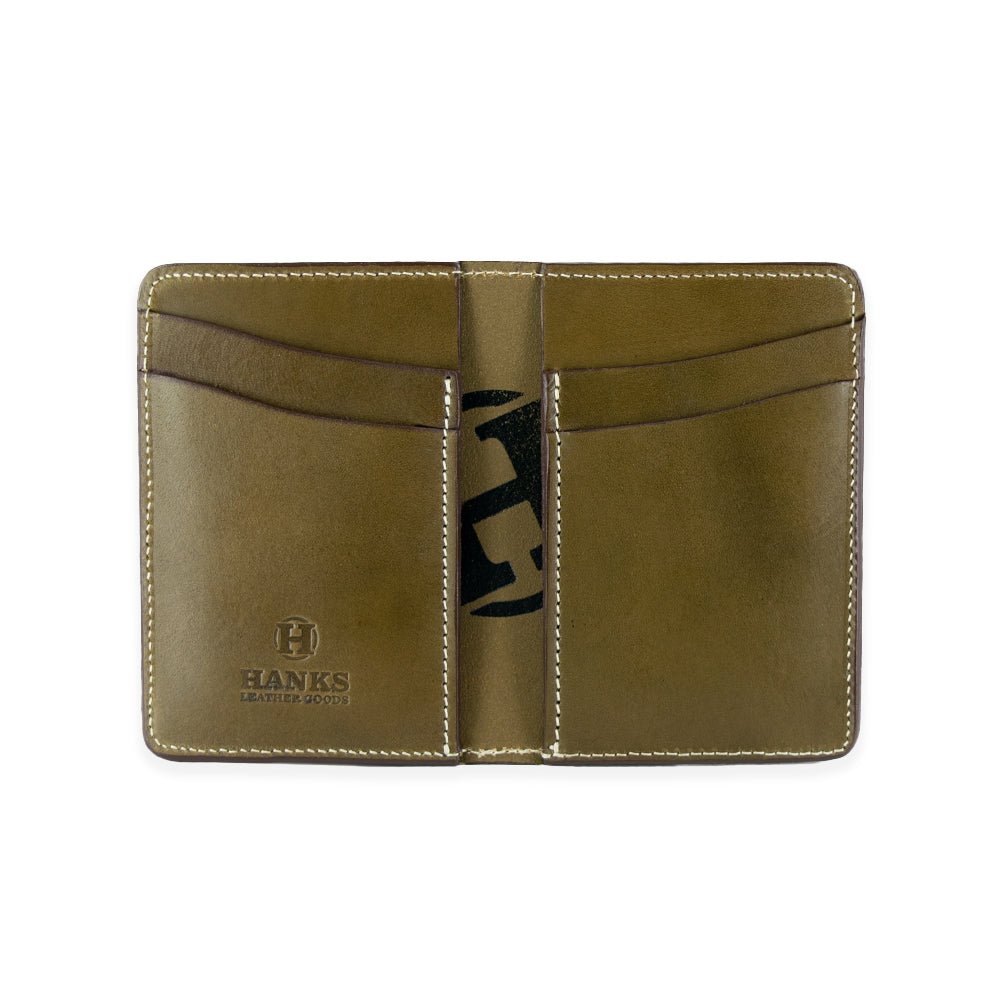 The Superior Front Pocket Bifold by Hanks Belts is an olive green, handcrafted wallet made from USA tanned English Bridle Leather. It features multiple card slots and has the &quot;Hanks Leather Goods&quot; logo embossed on the bottom left corner, shown against a plain white background.