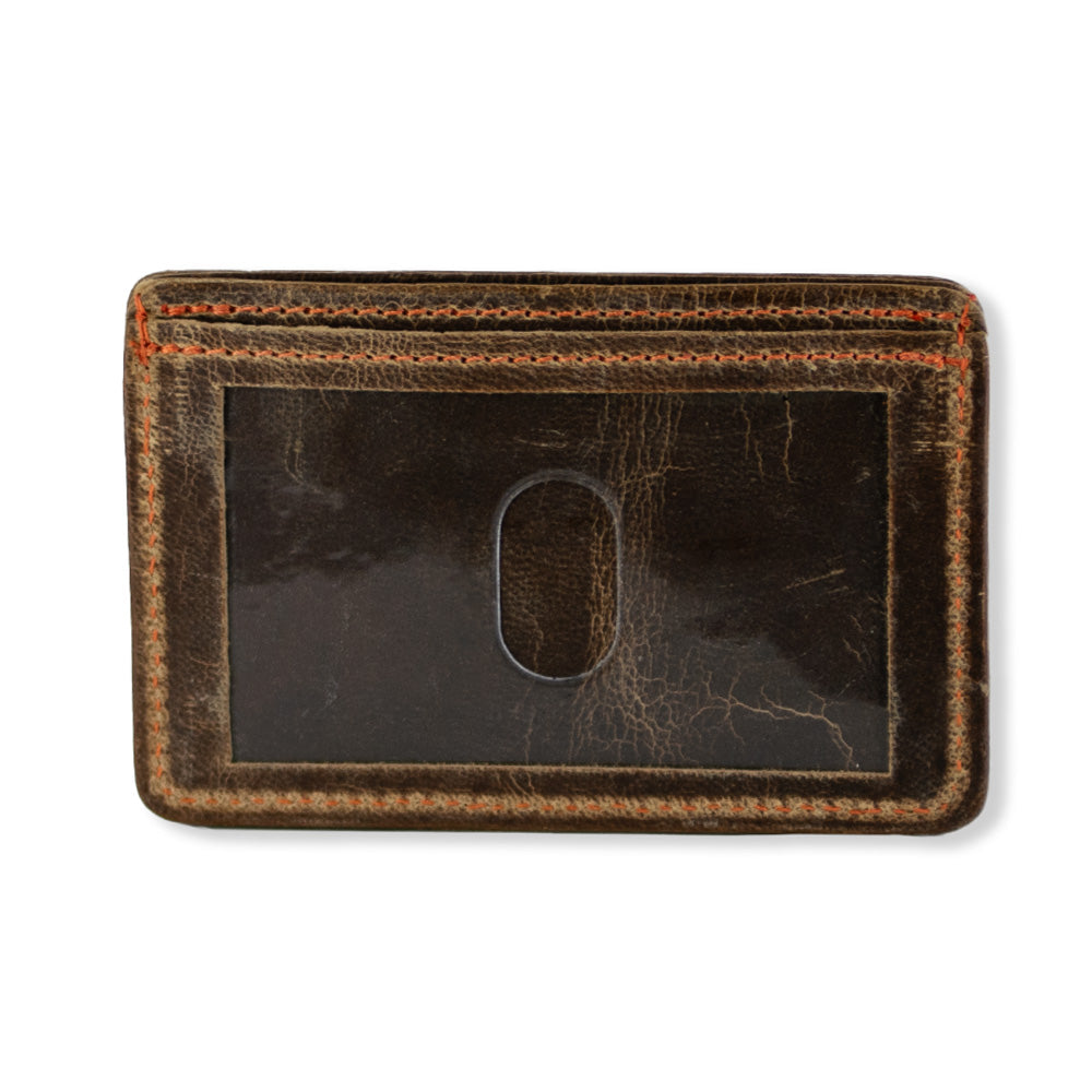 The Hamlin Card Holder with ID Window by Hanks Belts, made from durable steerhide leather, is a worn brown leather cardholder with visible stitching. It features a clear plastic window in the center with a thumb cut-out for easy access to the card inside. The edges are slightly worn, indicating frequent use and its Made in the USA quality.