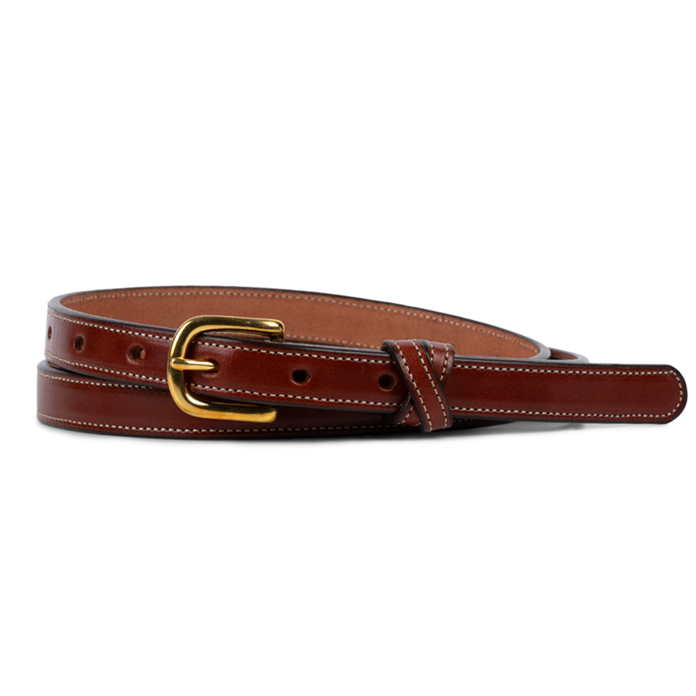 The Women&#39;s Dixie Belt by Hanks Belts is crafted from premium English bridle leather, highlighting American craftsmanship. It features white stitching, multiple holes, a gold buckle, and a loop keeper for added elegance in oak color.